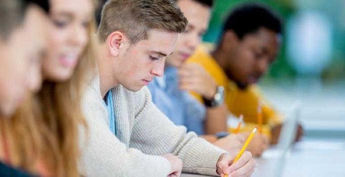 student writing on paper